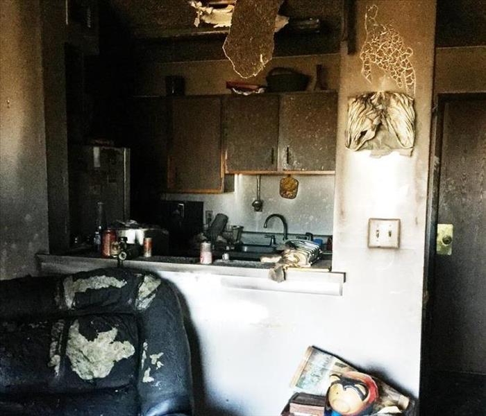 A severely damaged apartment after a fire with soot covering the walls