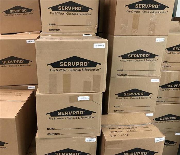 A stack of boxes with the SERVPRO logo and Barcodes