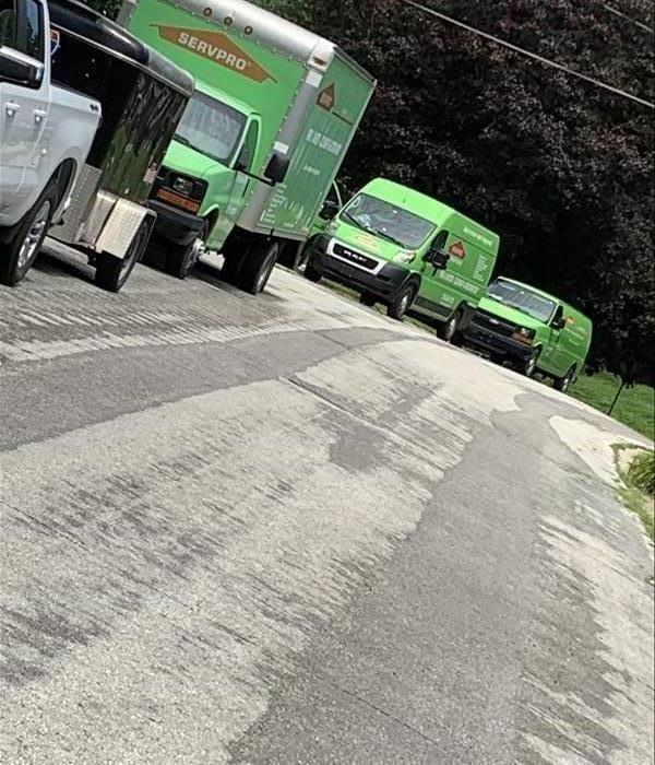 A parade of SERVPRO Vehicles during a storm event.